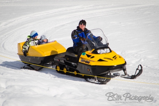 John Beckta Giving a Snowmobile Ride